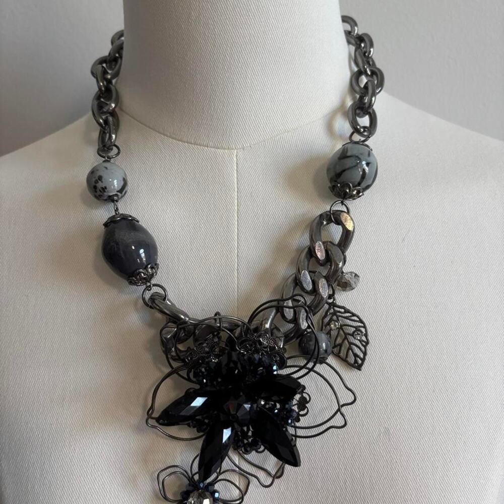 Black floral statement necklace with beads and wire accents.